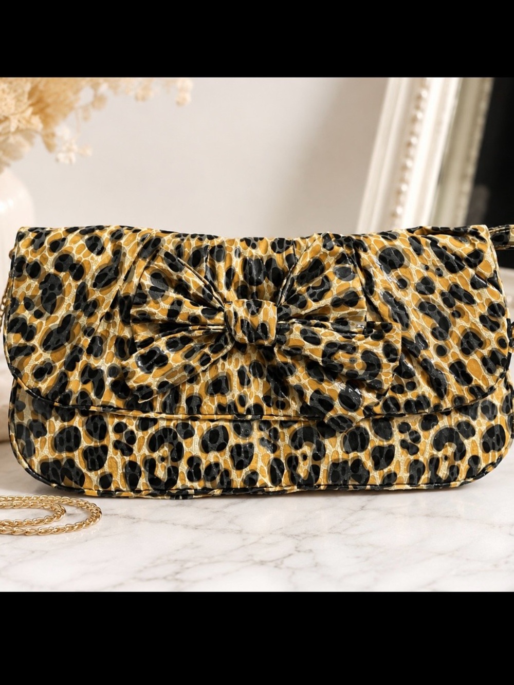 Stylish leopard print clutch with a large bow & silver chain shoulder strap